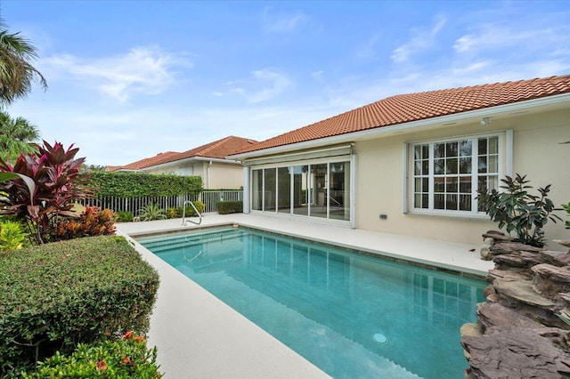 view of swimming pool with a fenced in pool and fence