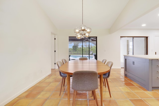 tiled dining area featuring a chandelier and vaulted ceiling