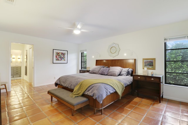 bedroom featuring ceiling fan, multiple windows, and light tile patterned floors