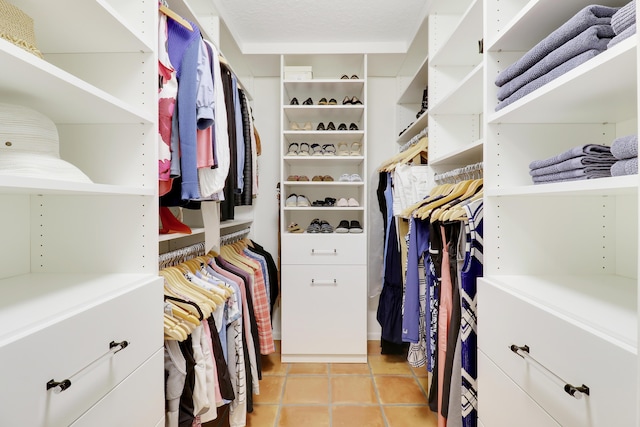 walk in closet with light tile patterned floors