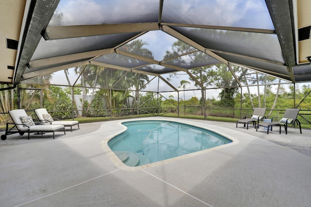 view of swimming pool with a lanai and a patio area