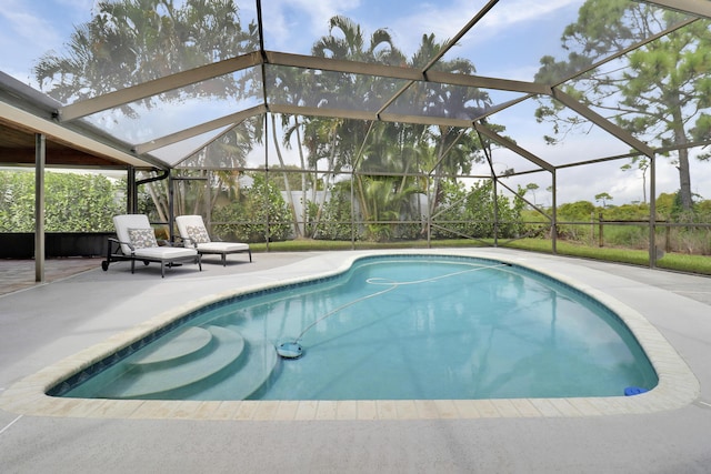 view of pool featuring a patio and glass enclosure