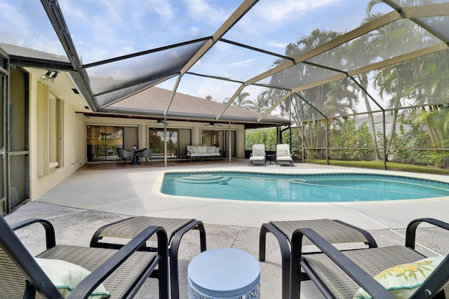 view of swimming pool featuring a lanai, a patio area, ceiling fan, and outdoor lounge area