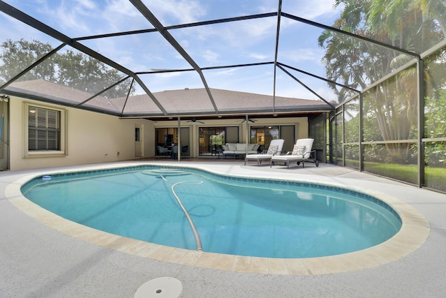 view of swimming pool with a lanai, a patio area, ceiling fan, and outdoor lounge area