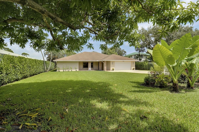 ranch-style home featuring a garage and a front lawn