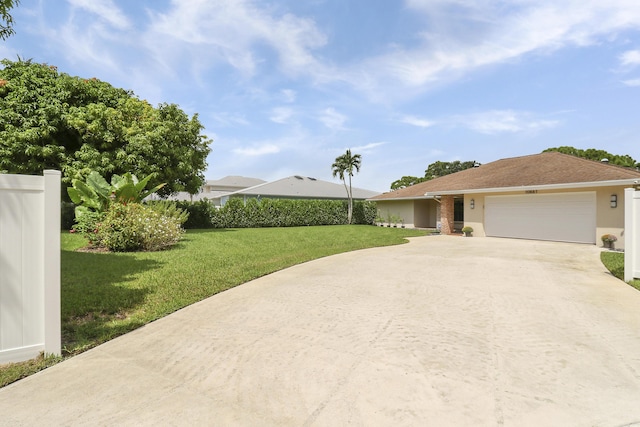 ranch-style house featuring a front yard and a garage