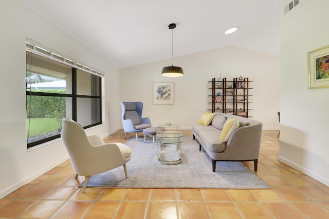 living room featuring lofted ceiling and tile patterned floors