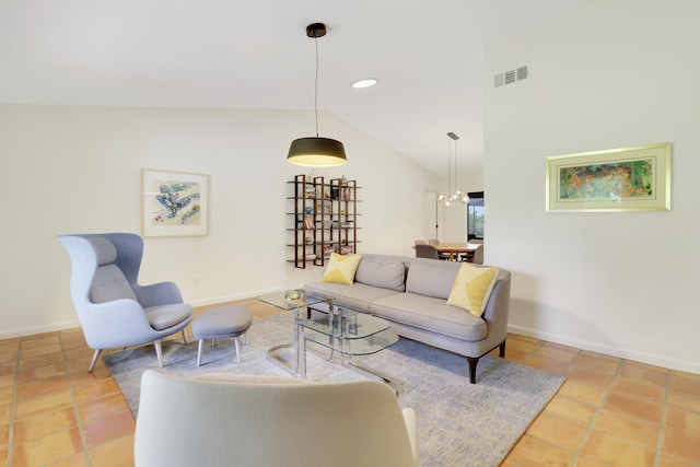 tiled living room featuring lofted ceiling and a chandelier