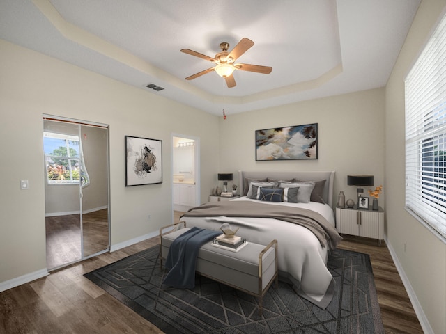 bedroom with dark hardwood / wood-style floors, ceiling fan, and multiple windows