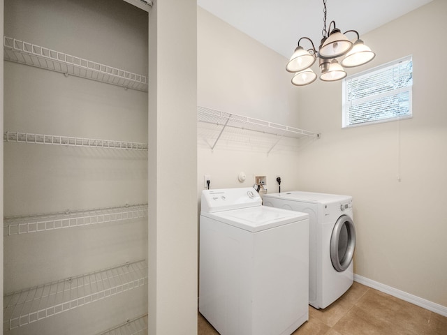 clothes washing area featuring a notable chandelier and independent washer and dryer