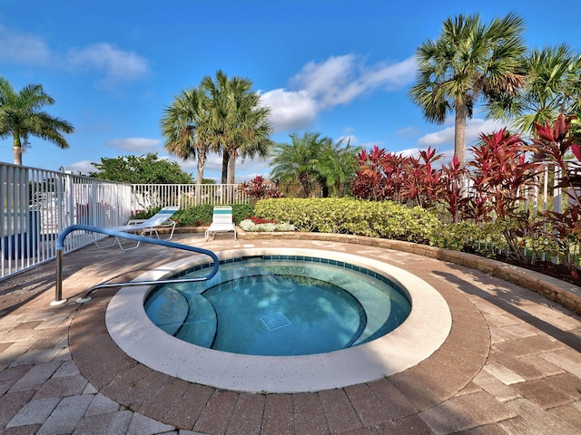 view of pool with an in ground hot tub and a patio area