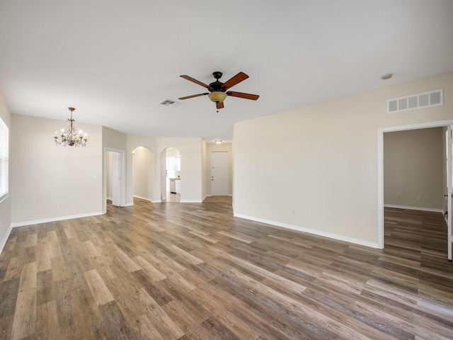 unfurnished living room with hardwood / wood-style floors and ceiling fan with notable chandelier