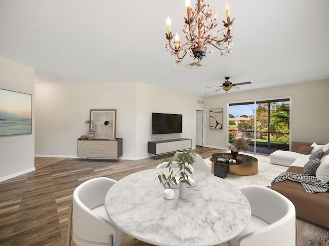 living room featuring wood-type flooring and ceiling fan with notable chandelier