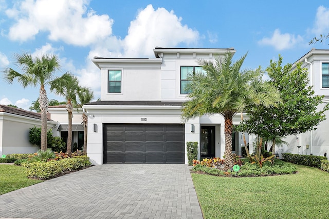 view of front facade with a front lawn and a garage