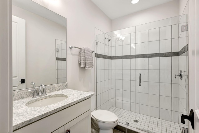 bathroom featuring walk in shower, vanity, and toilet