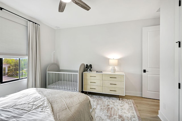 bedroom featuring ceiling fan and light hardwood / wood-style flooring