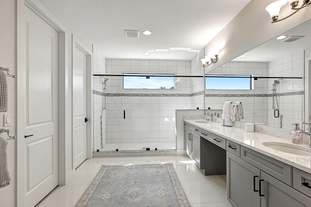 bathroom with tile patterned floors, plenty of natural light, vanity, and walk in shower