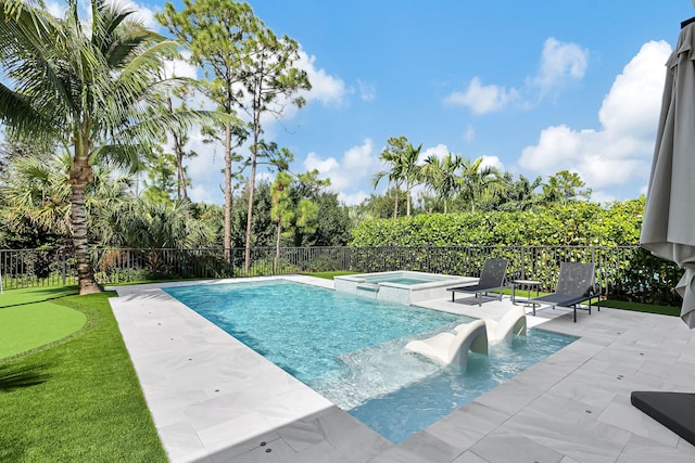 view of pool featuring a patio area and an in ground hot tub