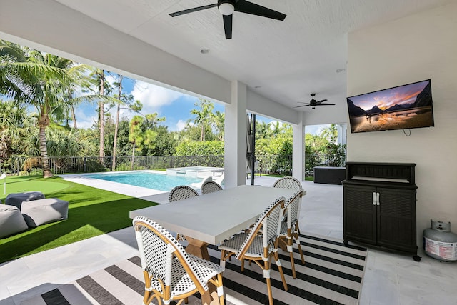 view of patio featuring a fenced in pool and ceiling fan