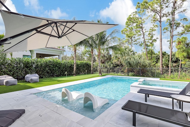 view of pool with an in ground hot tub and a lawn