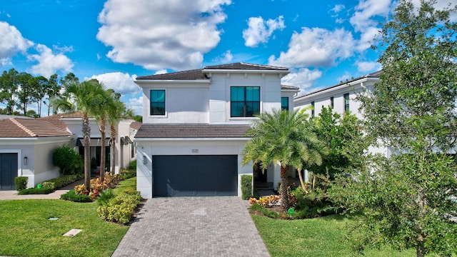 view of front facade with a garage and a front yard