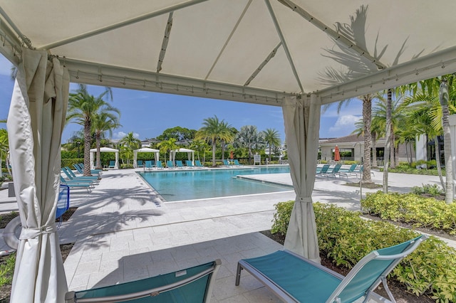 view of swimming pool with a gazebo and a patio area