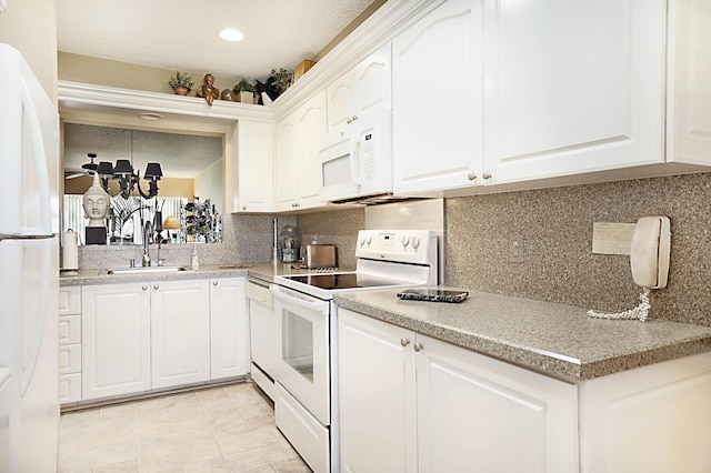 kitchen featuring white cabinetry, ceiling fan, sink, and white appliances