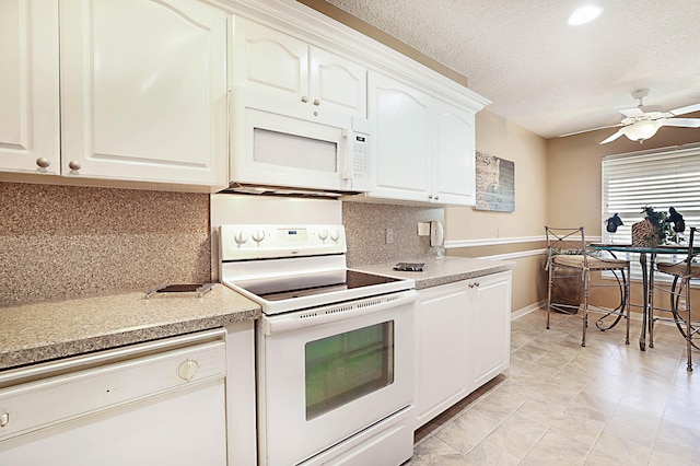 kitchen with tasteful backsplash, ceiling fan, white cabinetry, a textured ceiling, and white appliances