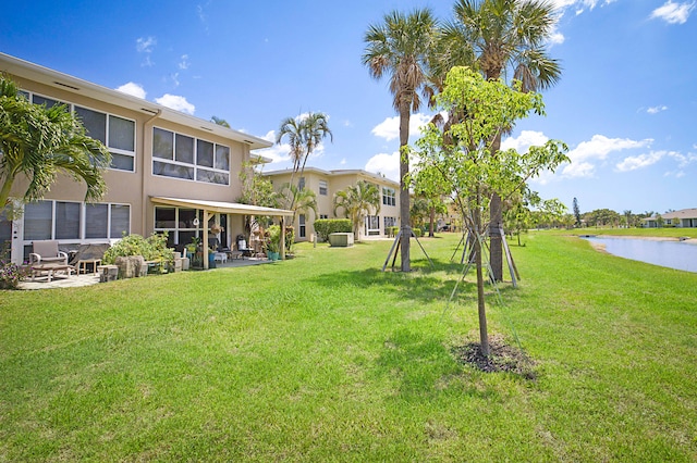 view of yard featuring a patio area and a water view