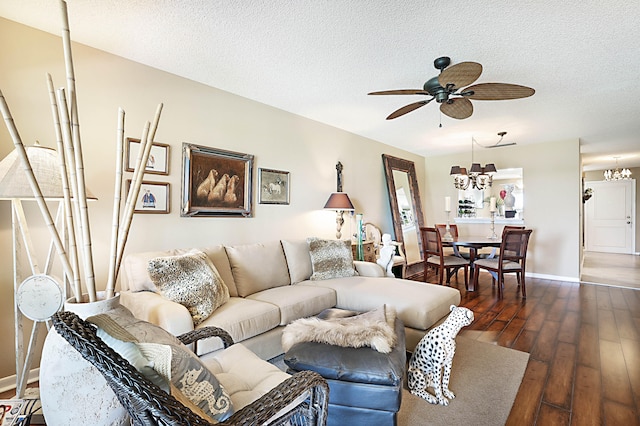 living room featuring dark hardwood / wood-style floors, a textured ceiling, and ceiling fan with notable chandelier