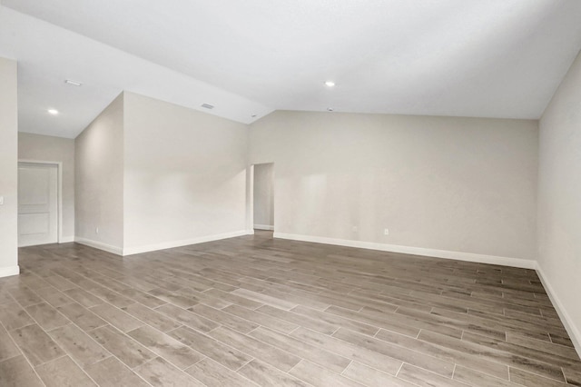 unfurnished room featuring lofted ceiling and light hardwood / wood-style floors