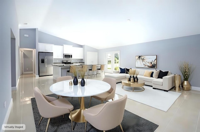 dining room with high vaulted ceiling