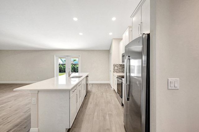 empty room with a raised ceiling and light hardwood / wood-style floors