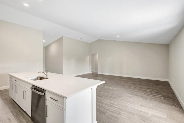 kitchen featuring lofted ceiling, sink, a kitchen island with sink, white cabinetry, and stainless steel dishwasher