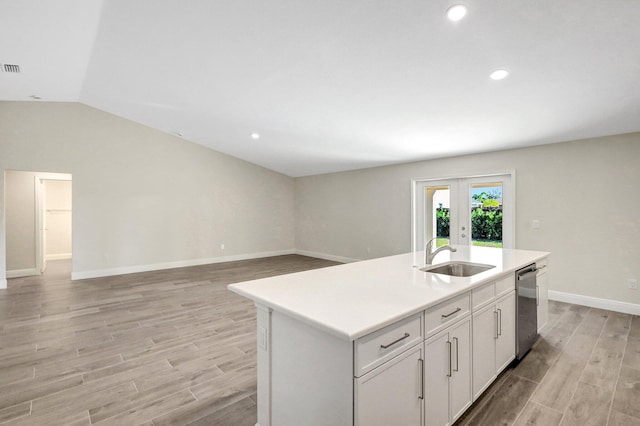 spare room featuring vaulted ceiling and light hardwood / wood-style floors