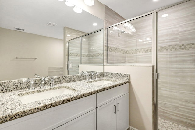 bathroom featuring vanity and a shower with shower door