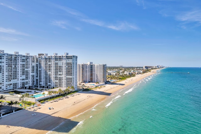 birds eye view of property featuring a water view and a beach view