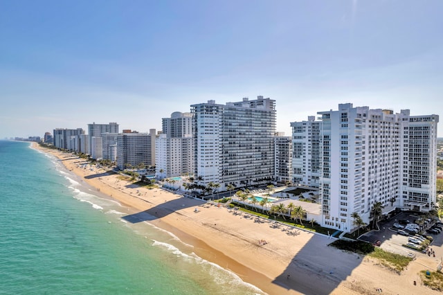 drone / aerial view featuring a water view and a beach view