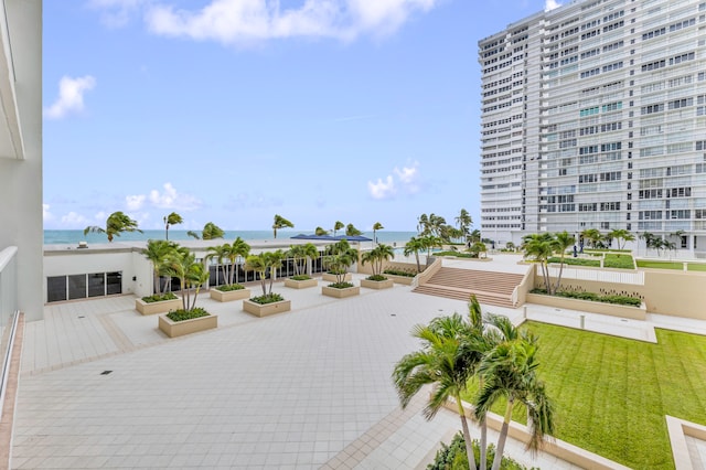 surrounding community featuring a lawn and a water view