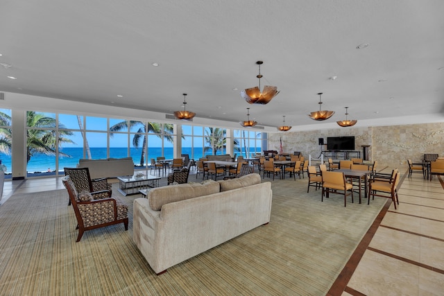 living room featuring a water view and light tile patterned floors