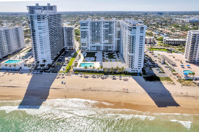 bird's eye view featuring a water view and a beach view