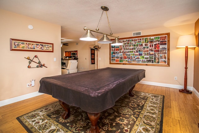 recreation room featuring ceiling fan, a textured ceiling, billiards, and hardwood / wood-style floors