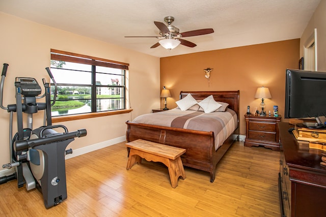 bedroom with light wood-type flooring and ceiling fan