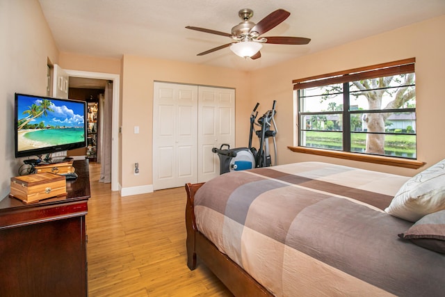 bedroom featuring a closet, ceiling fan, and light wood-type flooring