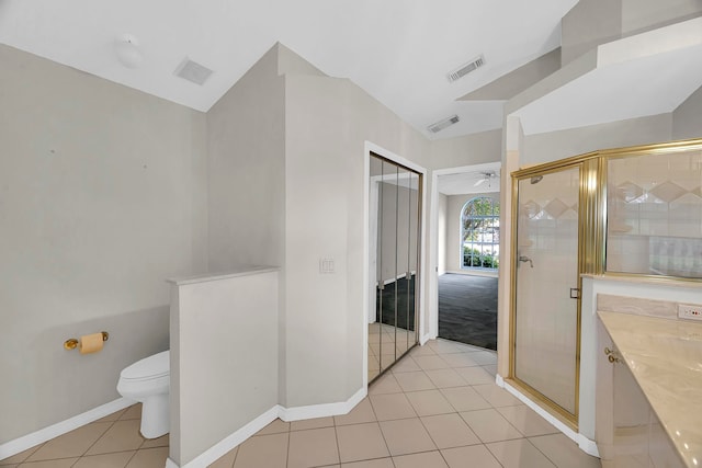 bathroom with toilet, walk in shower, vanity, and tile patterned floors