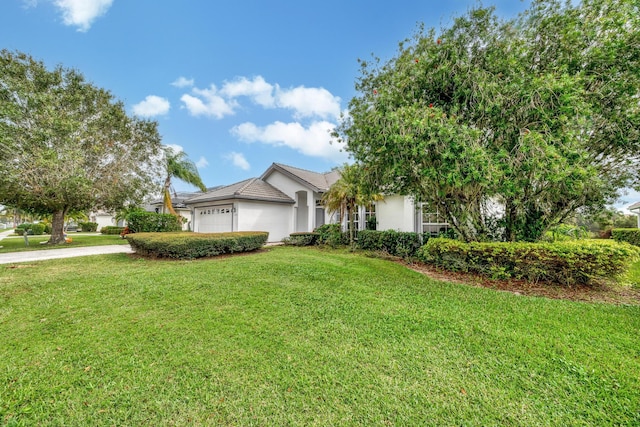 view of front of home with a front lawn and a garage