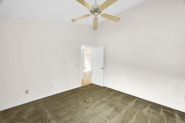 unfurnished room featuring a high ceiling, dark carpet, and ceiling fan