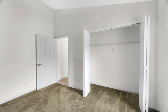 unfurnished bedroom featuring carpet and a closet