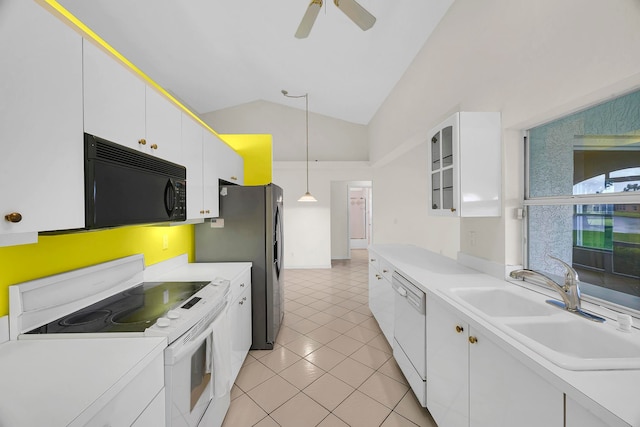 kitchen featuring lofted ceiling, white cabinets, hanging light fixtures, and white appliances