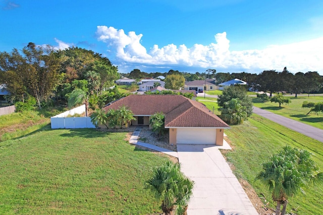view of front facade with concrete driveway, fence, a front lawn, and a garage